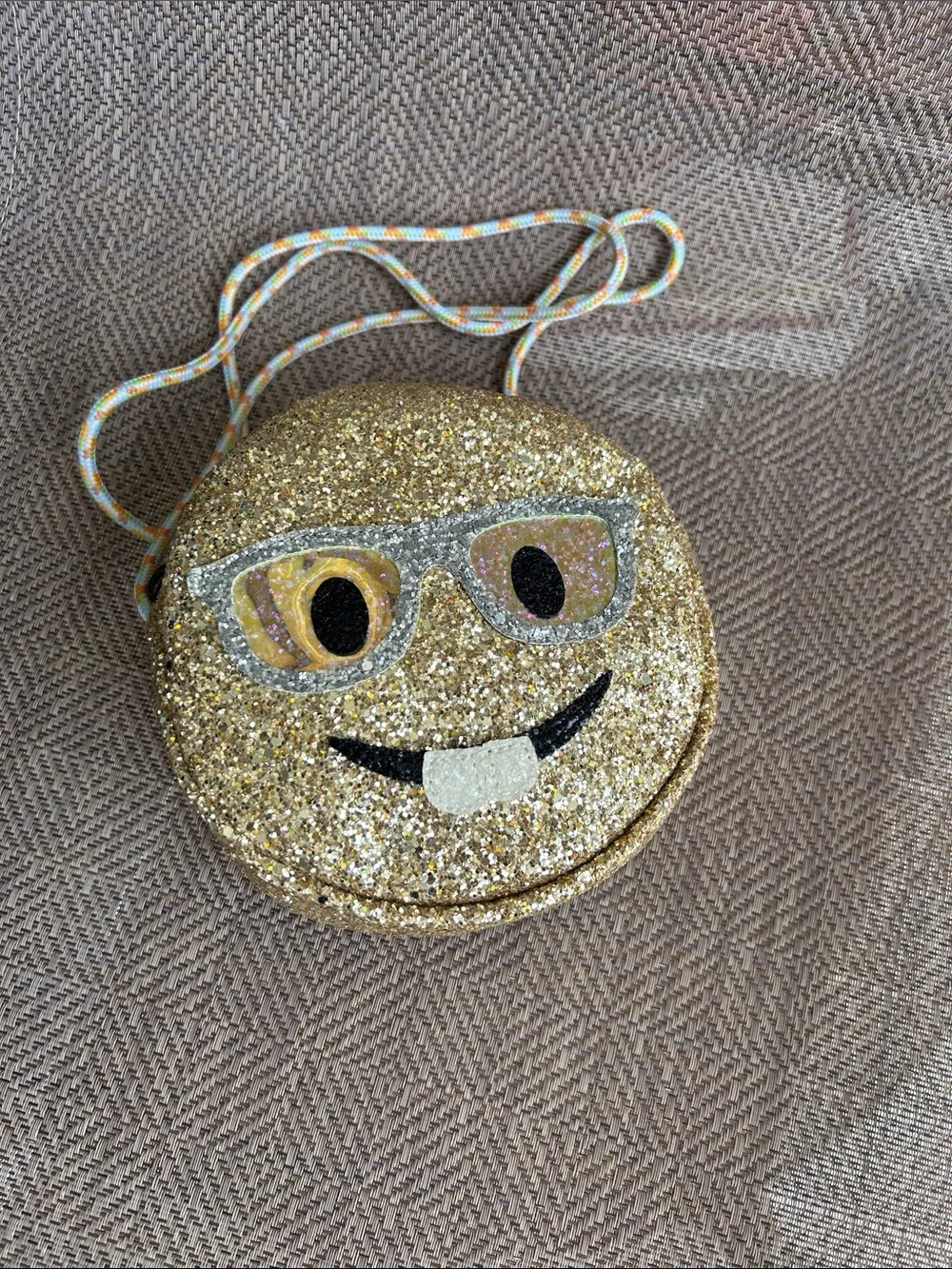Crewcuts Gold Glitter Emoji with buckteeth Crossbody Bag with Multicolor Cord.